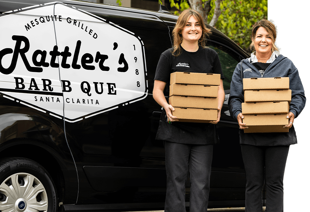 Two Rattler's team members with catering boxes